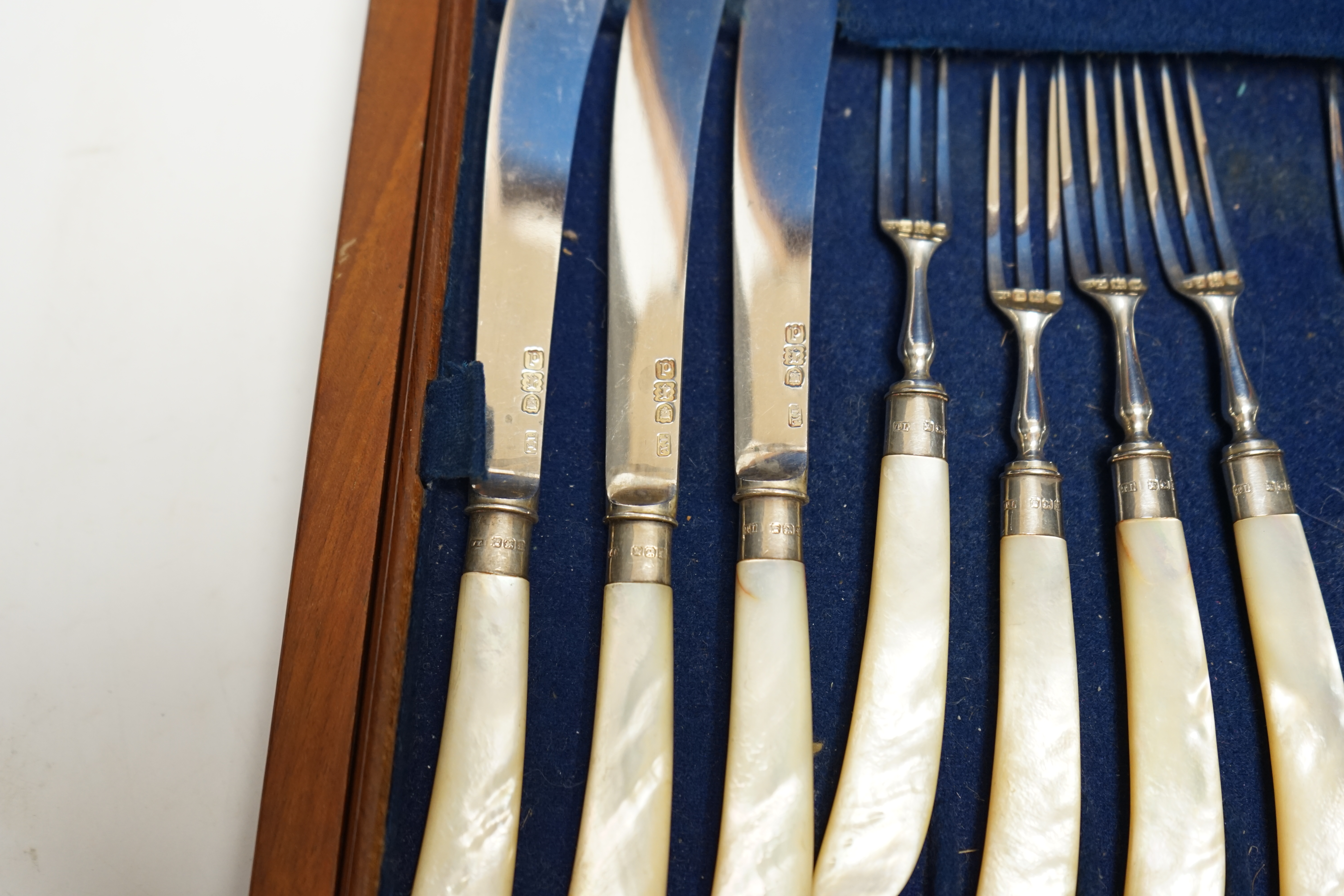 A set of twelve pairs of late Victorian mother of pearl pistol handled silver dessert eaters, by Levesley Brothers, London, 1899, in associated case. Condition - poor
